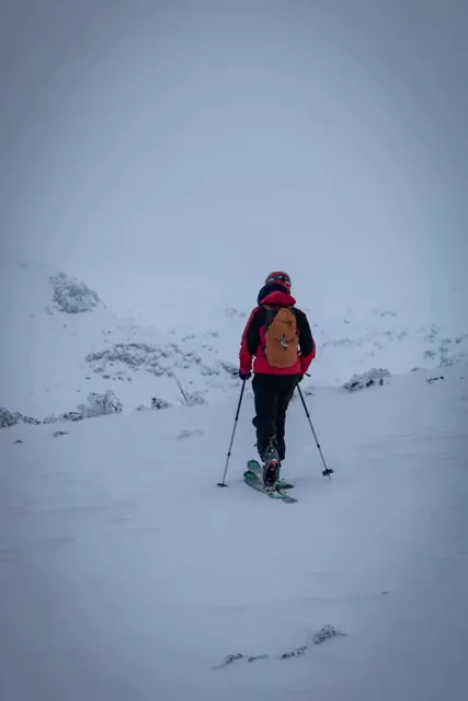 Trekkers walking through a snowy Himalayan landscape