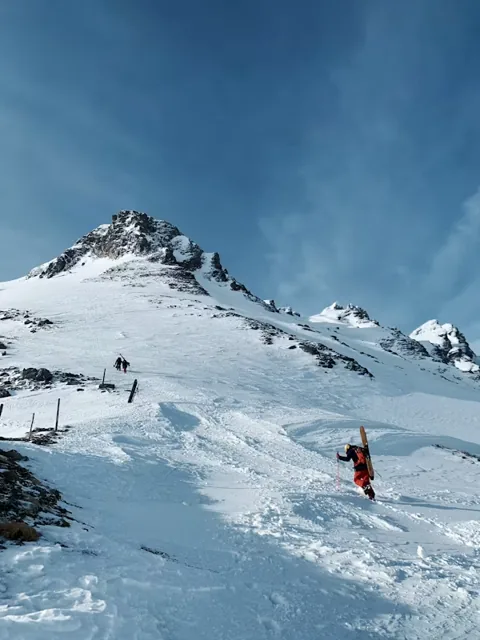 Trekkers walking through a snowy Himalayan landscape