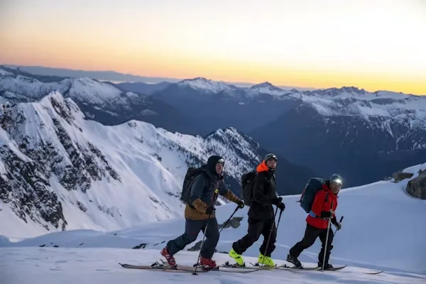 Trekkers walking through a snowy Himalayan landscape