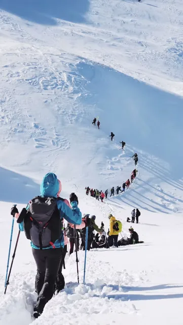 Trekkers walking through a snowy Himalayan landscape