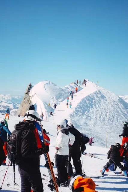 Trekkers walking through a snowy Himalayan landscape