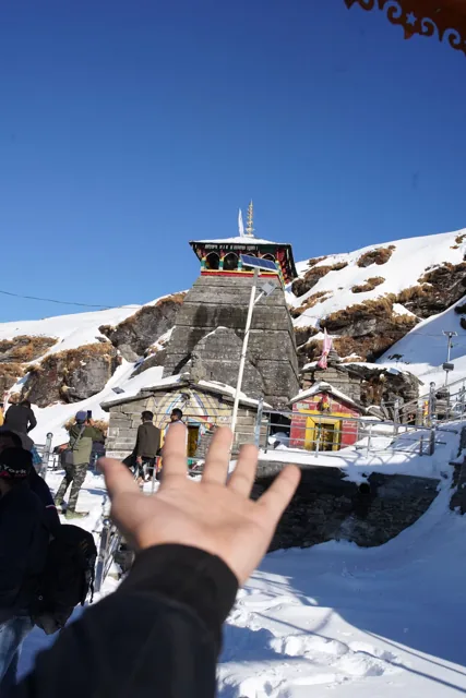 A traveller beside a snow-covered temple