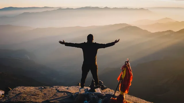 A traveller taking in a mountain sunset