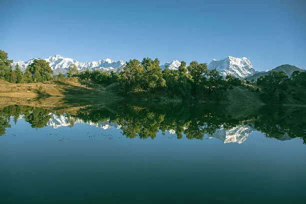 An alpine lake reflecting distant mountain peaks