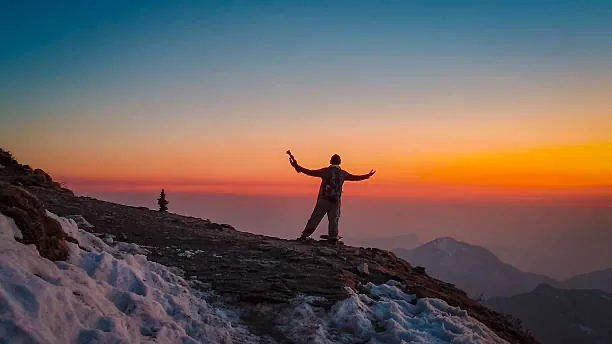 A traveller on a ridge at sunset